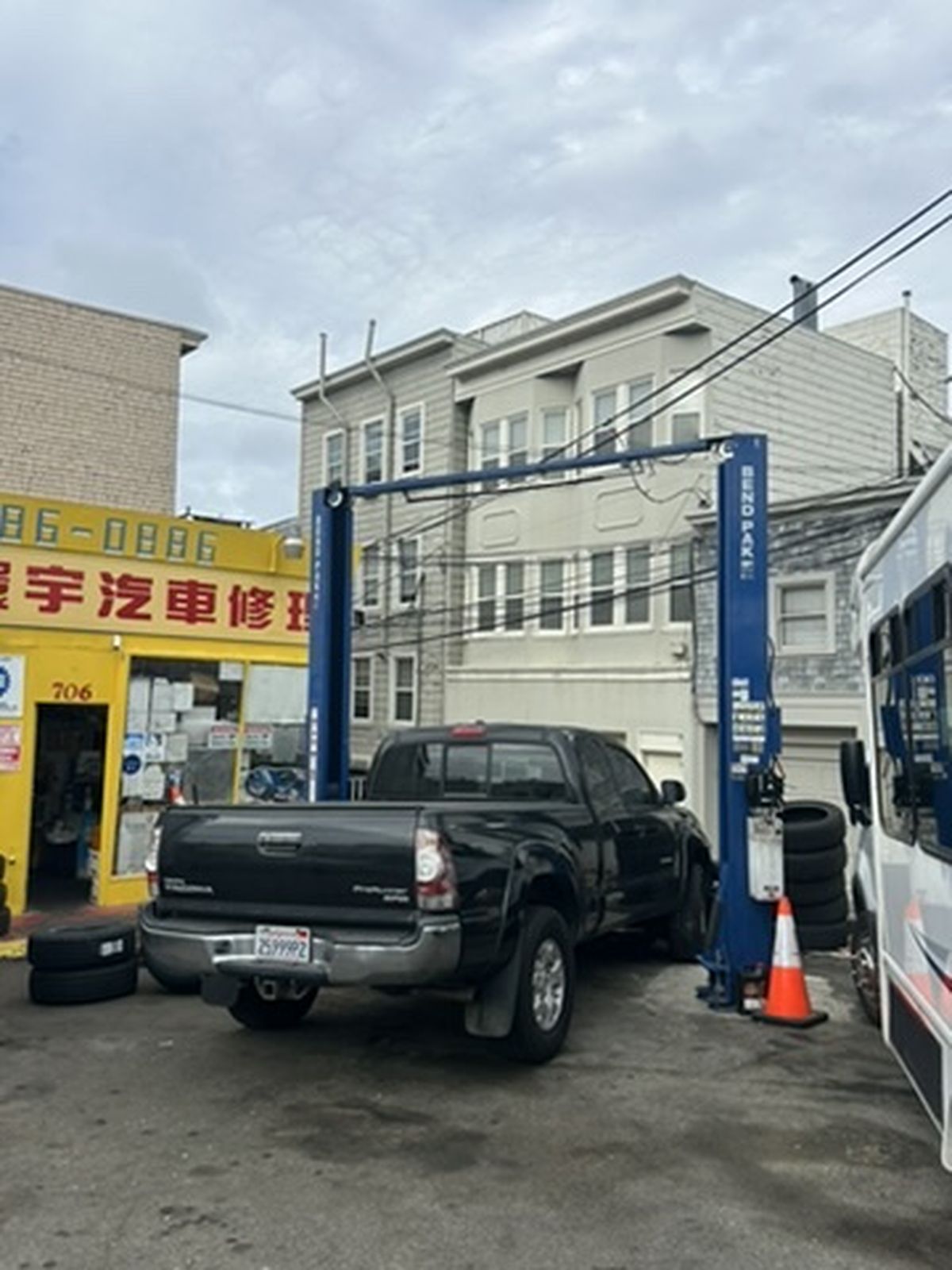 Truck on lift next to the shop